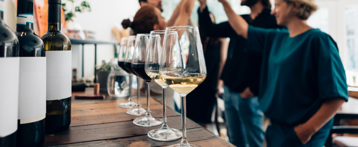 a glass of wine with vineyards in the background 